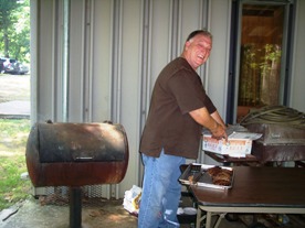 Dad Fortenberry grilling hamburgers and hot dogs